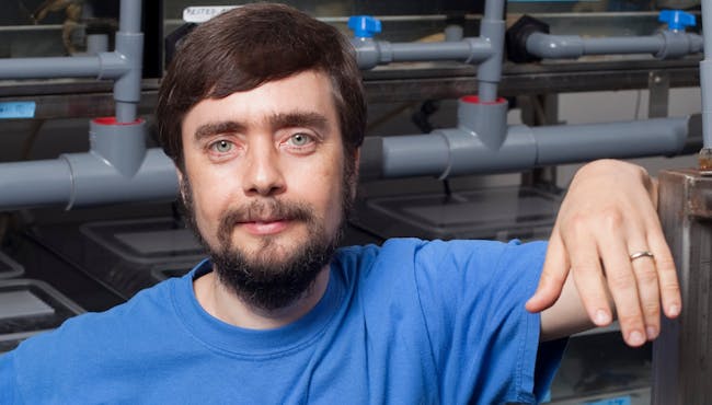 07/16/2012 - Medford, Mass. - Tufts University Biology professor Michael Levin poses for a portrait in his lab on July 16, 2012. Levin's research focuses on embryonic development and cellular regeneration, using frogs and tadpoles, among other organisms, to measure their regenerative properties. (Kelvin Ma/Tufts University)