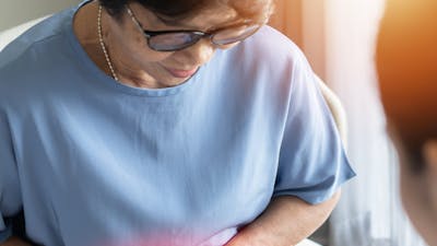 Abdominal pain in elder senior mature aging woman with stomachache illness from stomach cancer, irritable bowel syndrome, Indigestion, Diarrhea or GERD (gastro-esophageal reflux disease)
