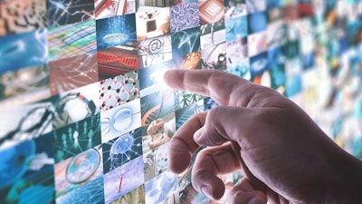 The hand touches the touchscreen led panel with various images about technology and science.