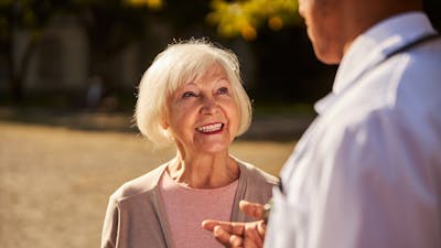 Cropped photo of a satisfied elderly patient trusting the explanation of her medical specialist