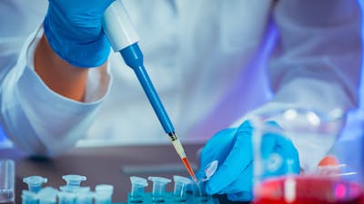 Female researcher using micro pipette