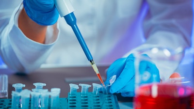 Female researcher using micro pipette